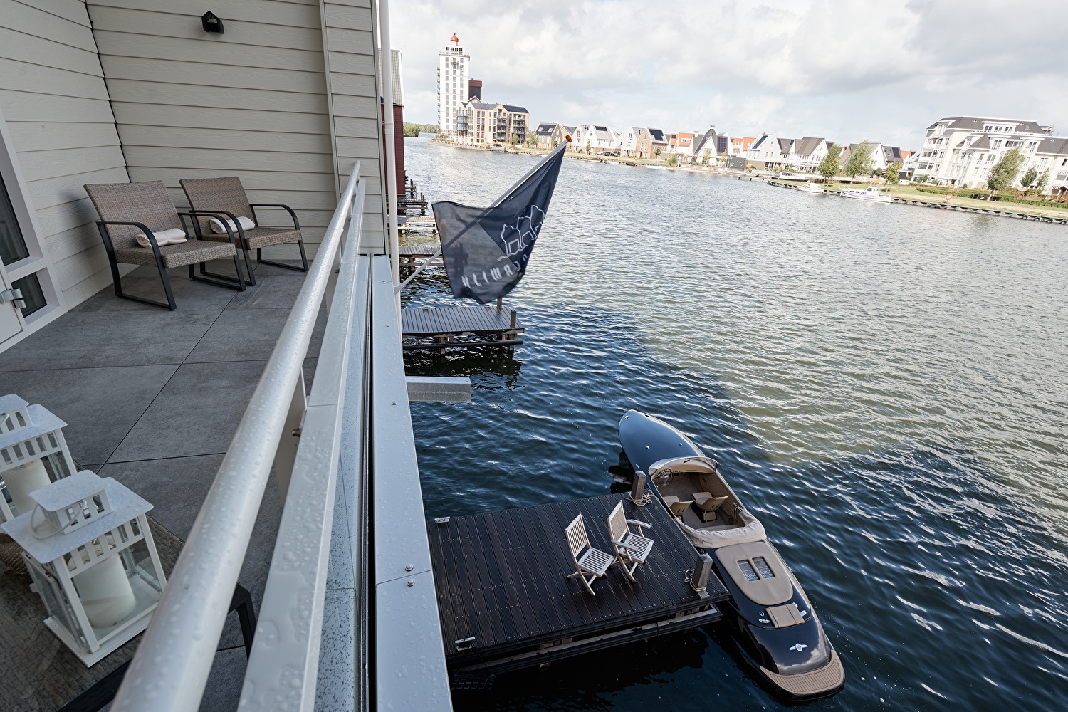 Balcony overlooking the water via glass balustrade